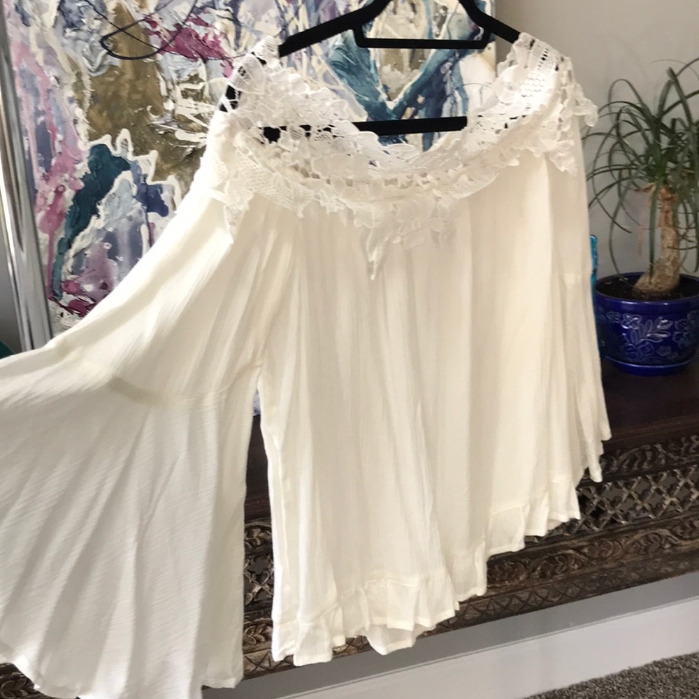 White, lace collared off-shoulder top.